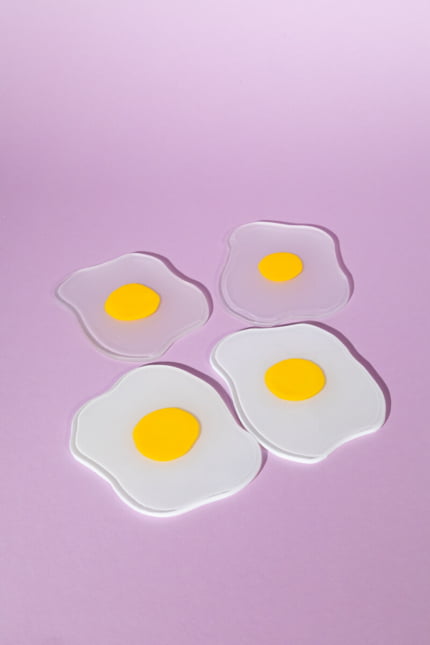 Squiggled raw to fried egg glass coasters set of four 2